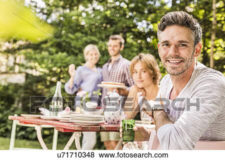 Group of friends at garden party View Large Photo Image Stock Photo - Group of friends at garden party. Fotosearch