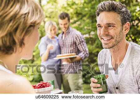 Stock Photography - Group of friends at garden party. Fotosearch