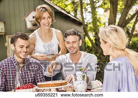 Group of friends enjoying garden party View Large Photo Image Stock Image - Group of friends enjoying garden party. Fotosearch