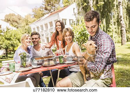 Group of friends enjoying garden party View Large Photo Image Stock Image - Group of friends enjoying garden party. Fotosearch