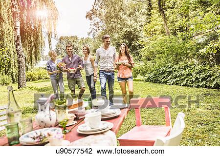Group of friends enjoying garden party View Large Photo Image Stock Image - Group of friends enjoying garden party. Fotosearch