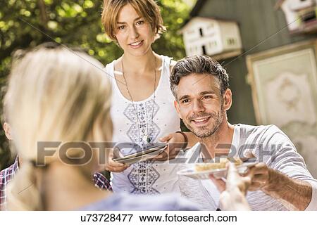 Group of friends enjoying garden party View Large Photo Image Stock Photo - Group of friends enjoying garden party. Fotosearch