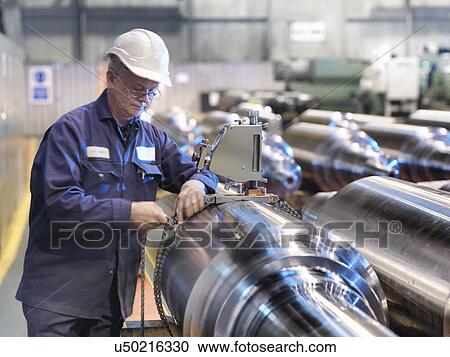 Stock Image - Hardness testing of steel part in engineering factory. Fotosearch