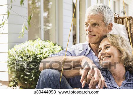 Husband and wife relaxing in garden View Large Photo Image Stock Image - Husband and wife relaxing in garden. Fotosearch