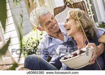 Husband and wife relaxing with bowl of cherries on hammock View Large Photo Image Stock Image - Husband and wife relaxing with bowl of cherries on hammock. Fotosearch