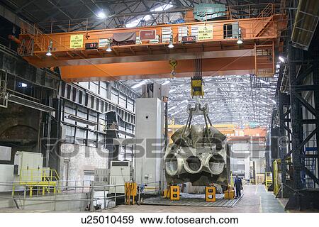 Stock Photo - Large casting on crane in engineering factory. Fotosearch