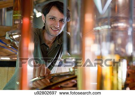 Male brewer working in brewhouse View Large Photo Image Stock Photo - Male brewer working in brewhouse. Fotosearch