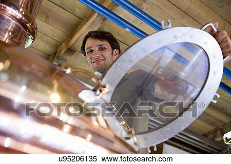 Male brewer working in brewhouse View Large Photo Image Stock Photography - Male brewer working in brewhouse. Fotosearch