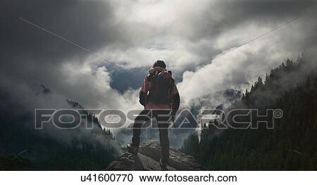"Male climber looking at storm clouds over valley, Chamonix, Mont Blanc, France" View Large Photo Image Stock Image - "Male climber looking at storm clouds over valley, Chamonix, Mont Blanc, France". Fotosearch