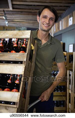 Picture - Man working in wine warehouse. Fotosearch