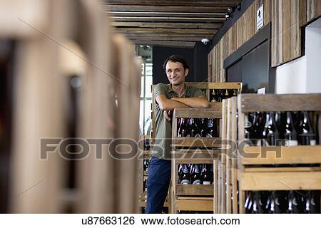 Man working in wine warehouse View Large Photo Image Stock Photograph - Man working in wine warehouse. Fotosearch