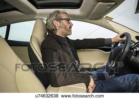 Stock Photo - Mature man driving car. Fotosearch