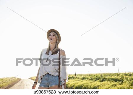 "Mid adult woman on country road, laughing" View Large Photo Image Stock Photo - "Mid adult woman on country road, laughing". Fotosearch