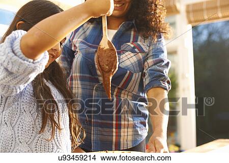 Mother and daughter baking in kitchen View Large Photo Image Picture - Mother and daughter baking in kitchen. Fotosearch