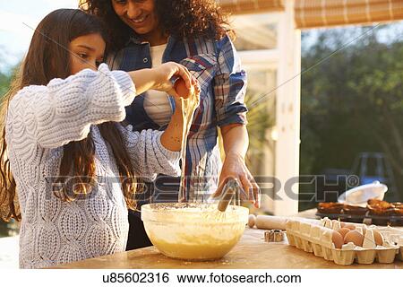 Mother and daughter baking in kitchen View Large Photo Image Stock Photograph - Mother and daughter baking in kitchen. Fotosearch