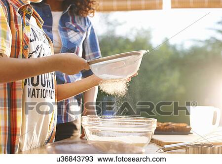 Mother and son baking in kitchen View Large Photo Image Stock Image - Mother and son baking in kitchen. Fotosearch