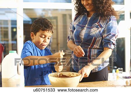 Stock Image - Mother and son baking in kitchen. Fotosearch