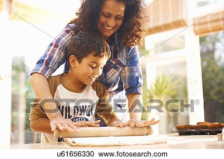 Mother and son baking in kitchen View Large Photo Image Stock Image - Mother and son baking in kitchen. Fotosearch