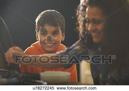 Mother painting sons pumpkin face for halloween View Large Photo Image Stock Photography - Mother painting sons pumpkin face for halloween. Fotosearch