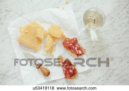 Stock Photo - "Parmesan cheese, salami, white wine, knife". Fotosearch