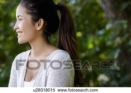 Portrait of beautiful young woman in park View Large Photo Image Stock Photography - Portrait of beautiful young woman in park. Fotosearch