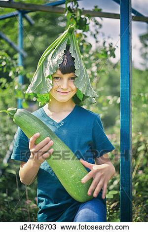 Portrait of boy with leaf hat and marrow on allotment View Large Photo Image Stock Image - Portrait of boy with leaf hat and marrow on allotment. Fotosearch