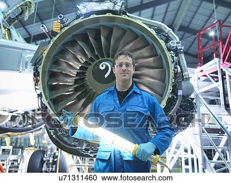 Portrait of engineer in front of jet engine in aircraft maintenance factory View Large Photo Image Stock Image - Portrait of engineer in front of jet engine in aircraft maintenance factory. Fotosearch