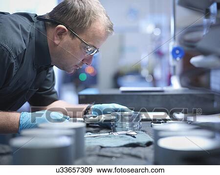 Portrait of engineer measuring engineered part in factory View Large Photo Image Stock Photo - Portrait of engineer measuring engineered part in factory. Fotosearch