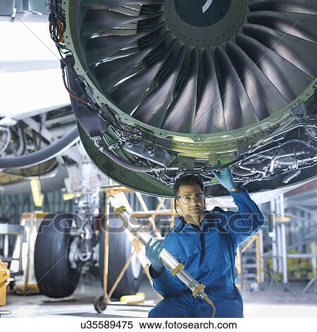 Portrait of engineer working on engine in aircraft maintenance factory View Large Photo Image Stock Photography - Portrait of engineer working on engine in aircraft maintenance factory. Fotosearch