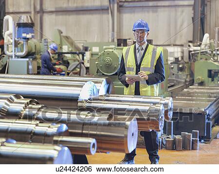 Stock Photograph - Portrait of manager in engineering factory. Fotosearch