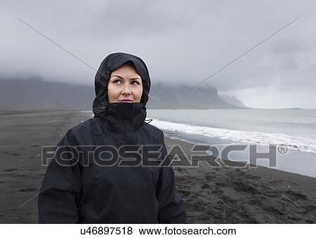 "Portrait of mid adult woman on black sand beach in rain, Stokksnes, Iceland" View Large Photo Image Stock Photo - "Portrait of mid adult woman on black sand beach in rain, Stokksnes, Iceland". Fotosearch