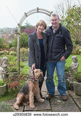 Portrait of senior couple with dog in garden View Large Photo Image Stock Photo - Portrait of senior couple with dog in garden. Fotosearch