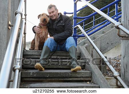 Portrait of senior man with dog sitting on steps View Large Photo Image Stock Photography - Portrait of senior man with dog sitting on steps. Fotosearch