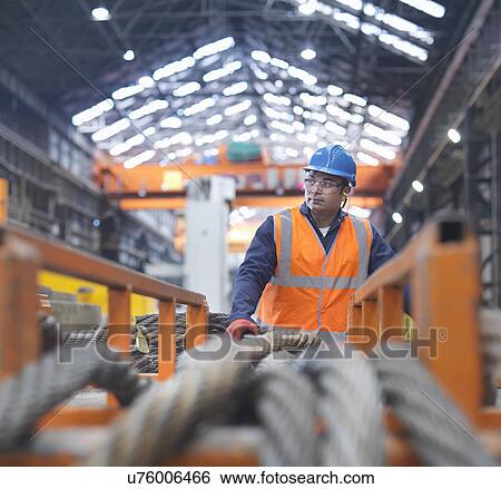 Stock Photograph - Portrait of steelworker in engineering factory. Fotosearch