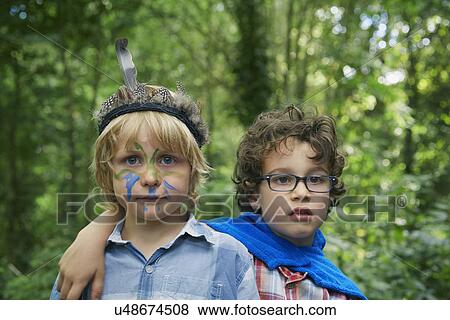 Portrait of two boys in forest with face paint View Large Photo Image Stock Photo - Portrait of two boys in forest with face paint. Fotosearch