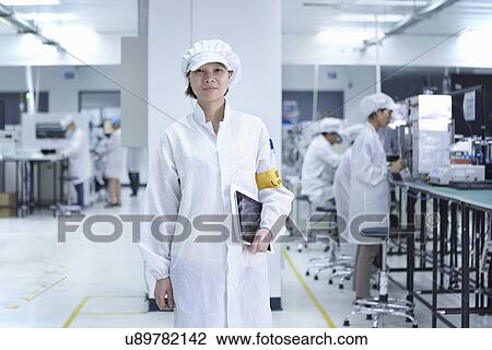Stock Image - Portrait of worker in factory that specialises in creating functional circuits on flexible surfaces. Fotosearch