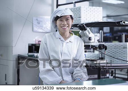 Stock Photo - Portrait of worker in factory that specialises in creating functional circuits on flexible surfaces. Fotosearch