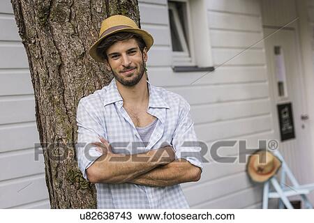 Portrait of young man outside house View Large Photo Image Stock Image - Portrait of young man outside house. Fotosearch