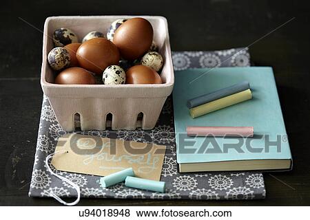 Stock Photo - "Quail and chicken eggs, chalk, notebook, kitchen towel". Fotosearch