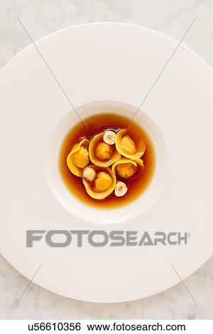 Stock Photograph - "Ravioli, hazelnuts in broth". Fotosearch