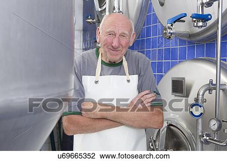 "Senior man wearing apron in brewhouse, portrait" View Large Photo Image Stock Image - "Senior man wearing apron in brewhouse, portrait". Fotosearch