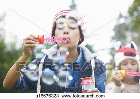 Siblings blowing bubbles in garden View Large Photo Image Stock Image - Siblings blowing bubbles in garden. Fotosearch