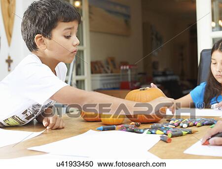 Siblings drawing at dining table View Large Photo Image Stock Image - Siblings drawing at dining table. Fotosearch