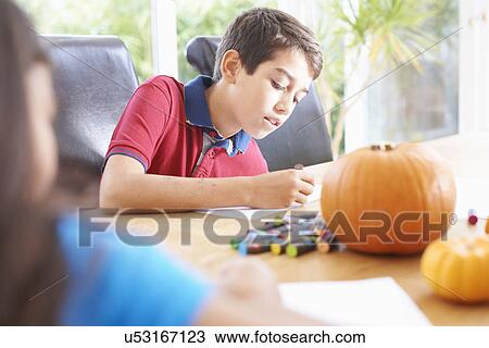 Siblings drawing at dining table View Large Photo Image Stock Image - Siblings drawing at dining table. Fotosearch