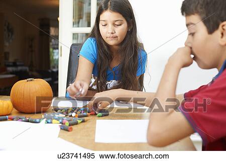 Siblings drawing at dining table View Large Photo Image Stock Photography - Siblings drawing at dining table. Fotosearch