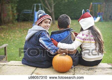 Siblings sitting on steps in garden View Large Photo Image Stock Image - Siblings sitting on steps in garden. Fotosearch