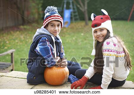 Siblings sitting on steps in garden View Large Photo Image Stock Image - Siblings sitting on steps in garden. Fotosearch