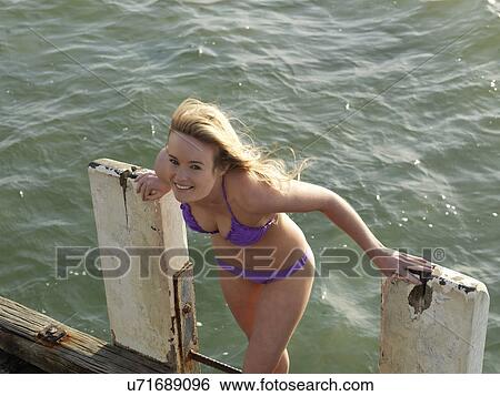 "Smiling young woman on pier ladder, Altona, Melbourne, Victoria, Australia" View Large Photo Image Stock Photograph - "Smiling young woman on pier ladder, Altona, Melbourne, Victoria, Australia". Fotosearch