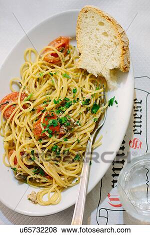 Stock Photo - "Spaghetti with tomato, parsley and bread". Fotosearch