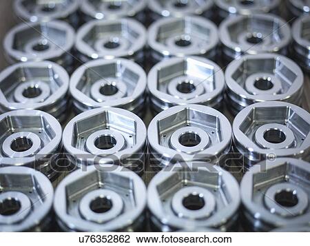 Stock Image - "Steel parts on production line in engineering factory, close up". Fotosearch